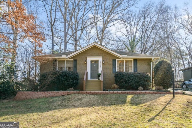 view of front facade with a front lawn and brick siding