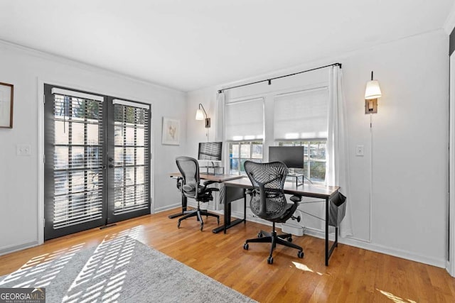 home office with french doors, wood finished floors, and baseboards