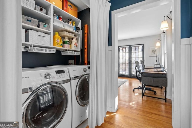 clothes washing area featuring laundry area, independent washer and dryer, and light wood-style floors