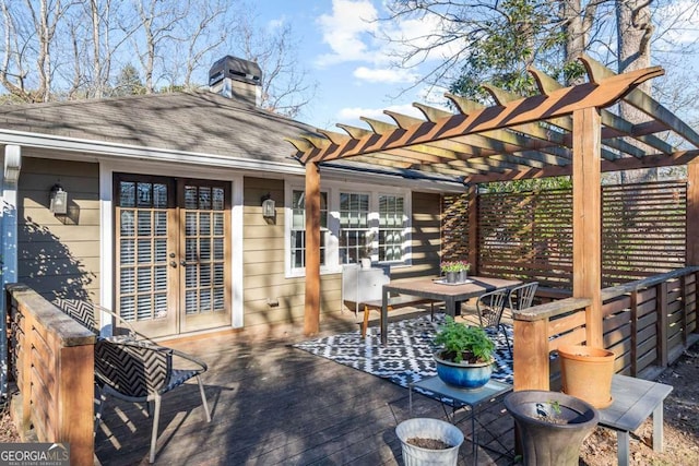 wooden terrace featuring french doors and a pergola