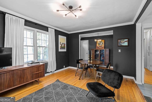 office area featuring light wood finished floors, visible vents, baseboards, crown molding, and a chandelier