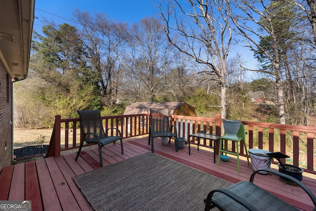 wooden deck with an outdoor structure and a storage shed