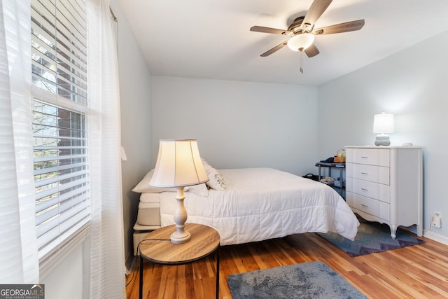 bedroom with ceiling fan and wood finished floors