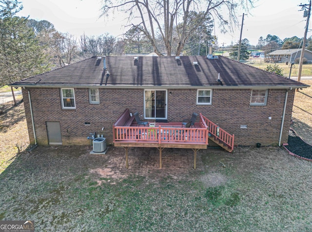 back of property with cooling unit, crawl space, brick siding, and a wooden deck