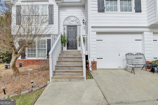 doorway to property with a garage