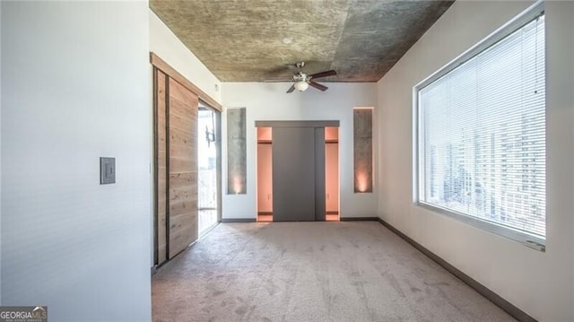 unfurnished bedroom with baseboards, a ceiling fan, and light colored carpet