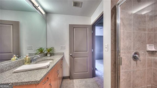 full bath with tile patterned flooring, visible vents, a shower stall, and vanity