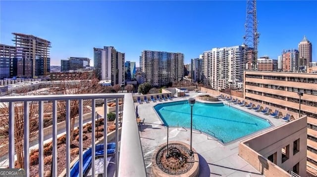 community pool with a patio and a city view