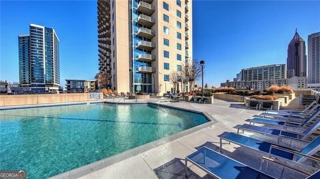 community pool featuring a patio area and a city view