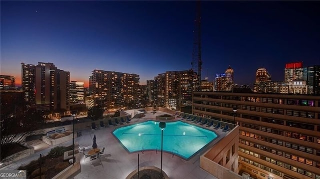 pool featuring a patio area and a view of city