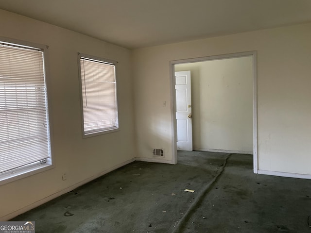 spare room with a healthy amount of sunlight and visible vents