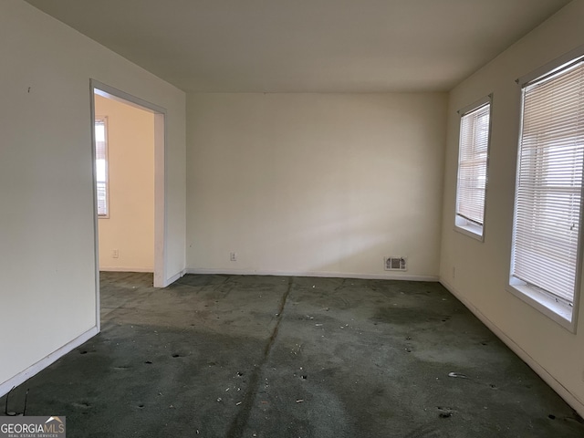 carpeted empty room with baseboards and visible vents