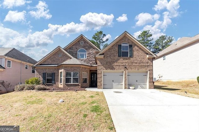 traditional-style home featuring concrete driveway, brick siding, a front lawn, and an attached garage