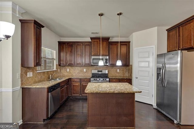 kitchen featuring appliances with stainless steel finishes, a sink, visible vents, and light stone countertops