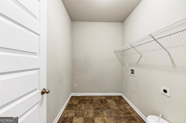 clothes washing area with laundry area, washer hookup, baseboards, stone finish floor, and electric dryer hookup