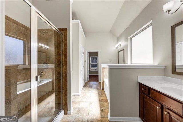 bathroom with a bath, a shower stall, vanity, and baseboards