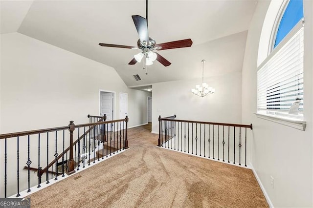 corridor featuring lofted ceiling, visible vents, an upstairs landing, baseboards, and an inviting chandelier