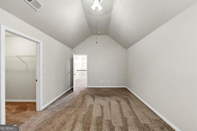 additional living space featuring lofted ceiling, carpet flooring, visible vents, and baseboards