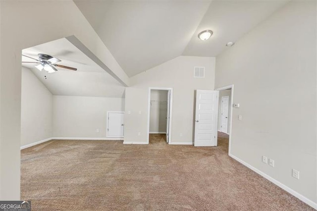 additional living space with visible vents, baseboards, ceiling fan, vaulted ceiling, and carpet floors