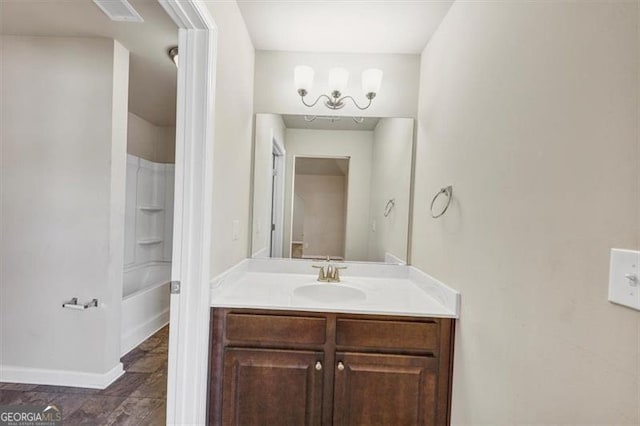 bathroom with washtub / shower combination, visible vents, vanity, and baseboards