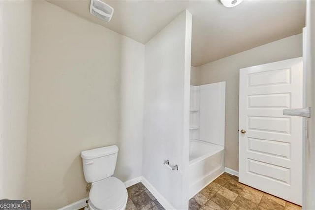 bathroom featuring toilet, visible vents, washtub / shower combination, and baseboards