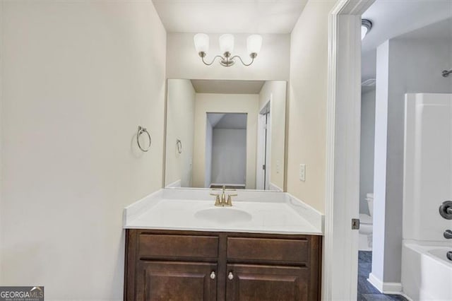 bathroom featuring toilet and vanity