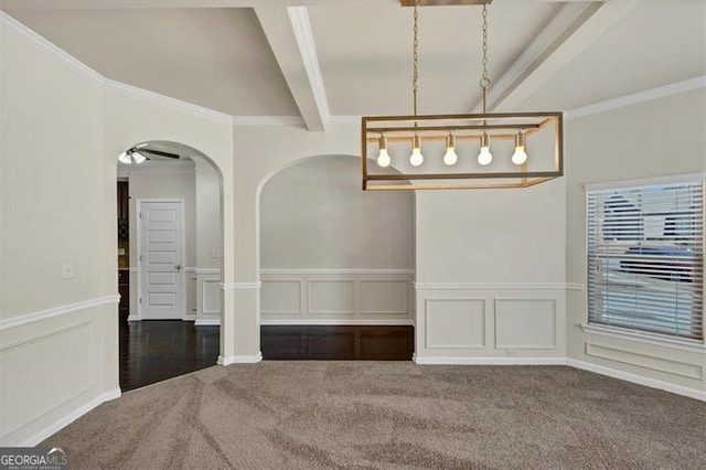 unfurnished dining area with carpet, crown molding, arched walkways, and beamed ceiling