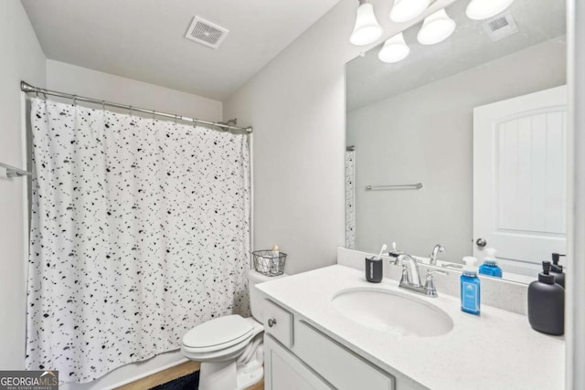 bathroom with toilet, a shower with shower curtain, vanity, and visible vents