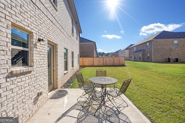 view of patio / terrace with outdoor dining space, fence, and central AC unit