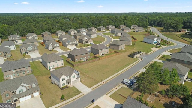 drone / aerial view with a residential view and a forest view