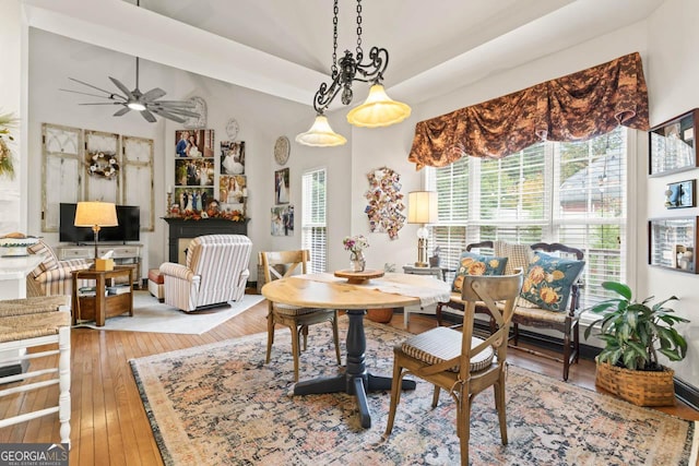 dining space featuring wood-type flooring and a ceiling fan