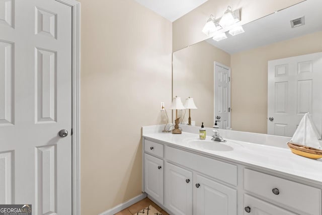 bathroom featuring baseboards, visible vents, tile patterned flooring, and vanity