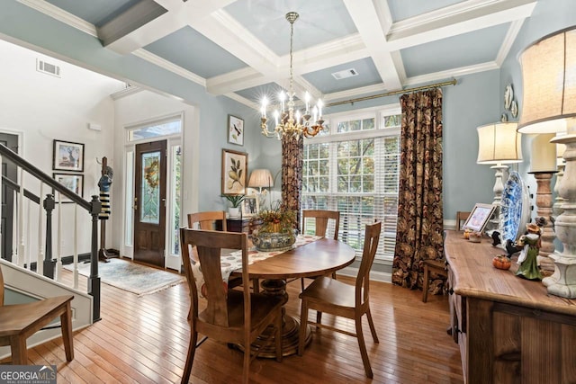 dining room featuring stairs, beam ceiling, hardwood / wood-style flooring, and visible vents