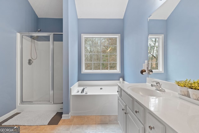 full bathroom featuring a shower stall, baseboards, a bath, and vanity