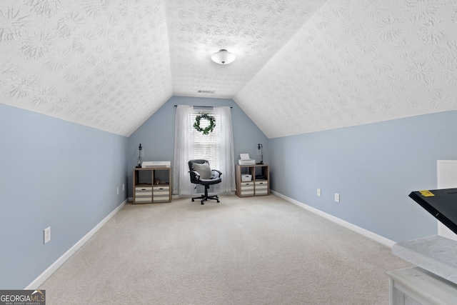 living area with visible vents, baseboards, vaulted ceiling, a textured ceiling, and carpet flooring