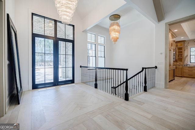 foyer entrance featuring parquet flooring, recessed lighting, baseboards, and an inviting chandelier