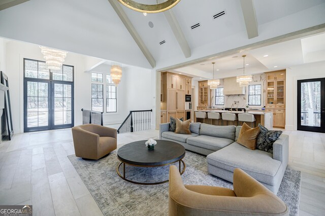 living area featuring beamed ceiling, visible vents, high vaulted ceiling, light wood-style flooring, and recessed lighting