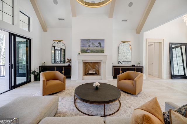 living area with beamed ceiling, visible vents, a high ceiling, a fireplace, and baseboards