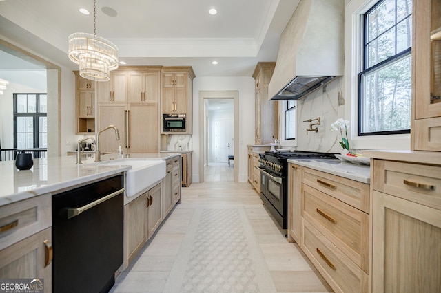 kitchen with a notable chandelier, black appliances, light brown cabinets, a sink, and custom exhaust hood