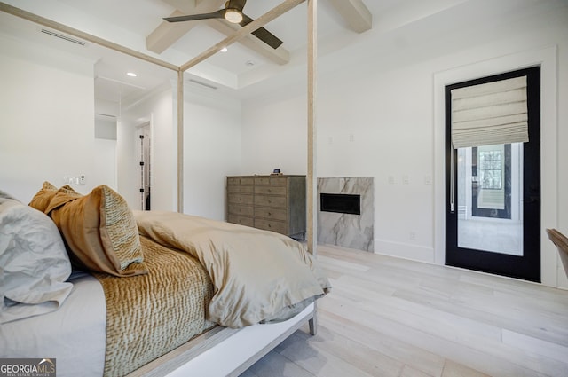 bedroom with beam ceiling, wood finished floors, visible vents, and coffered ceiling