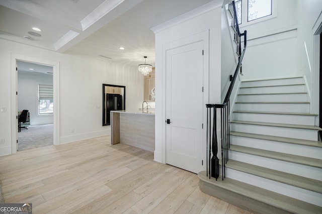 interior space with an inviting chandelier, recessed lighting, wood finished floors, and baseboards