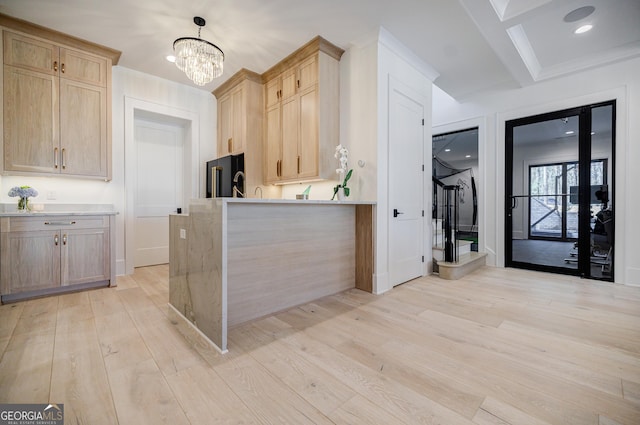 kitchen with light wood-style floors, light countertops, light brown cabinetry, and freestanding refrigerator