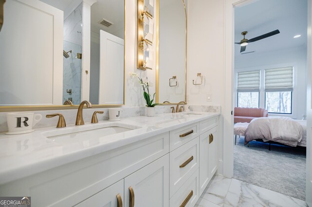 ensuite bathroom featuring a marble finish shower, visible vents, connected bathroom, marble finish floor, and a sink