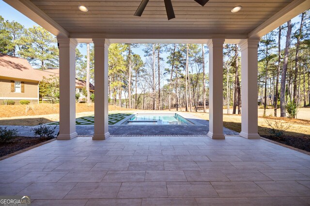 view of patio / terrace featuring a ceiling fan and an outdoor pool