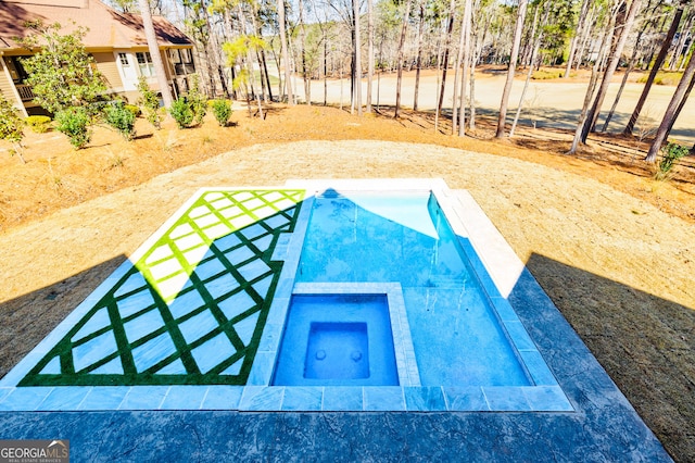 view of swimming pool with an in ground hot tub