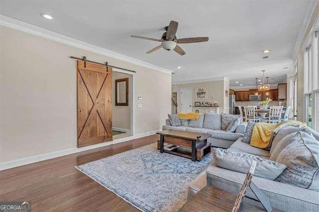 living area with ornamental molding, ceiling fan, baseboards, and dark wood-style floors