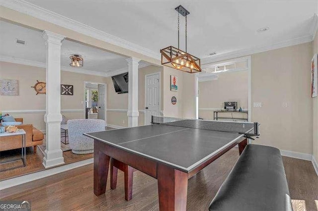 rec room with ornate columns, dark wood finished floors, and crown molding