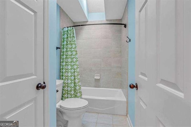 bathroom featuring shower / bath combo, toilet, and tile patterned floors