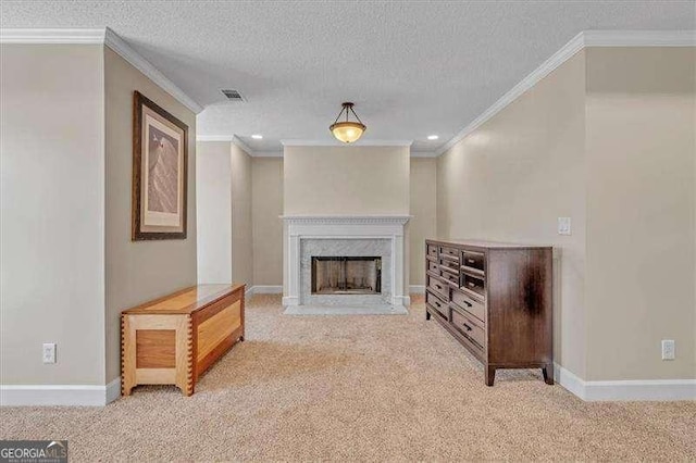 carpeted living area featuring visible vents, a textured ceiling, baseboards, and a premium fireplace