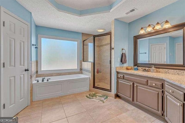 bathroom featuring a shower stall, a textured ceiling, visible vents, and a bath